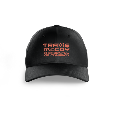 A black unstructured dad hat with "Travie McCoy" and "A Spoonful of Cinnamon" embroidered on the front